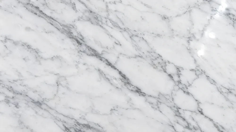 Close-up of polished white marble flooring with delicate gray veins and a glossy surface