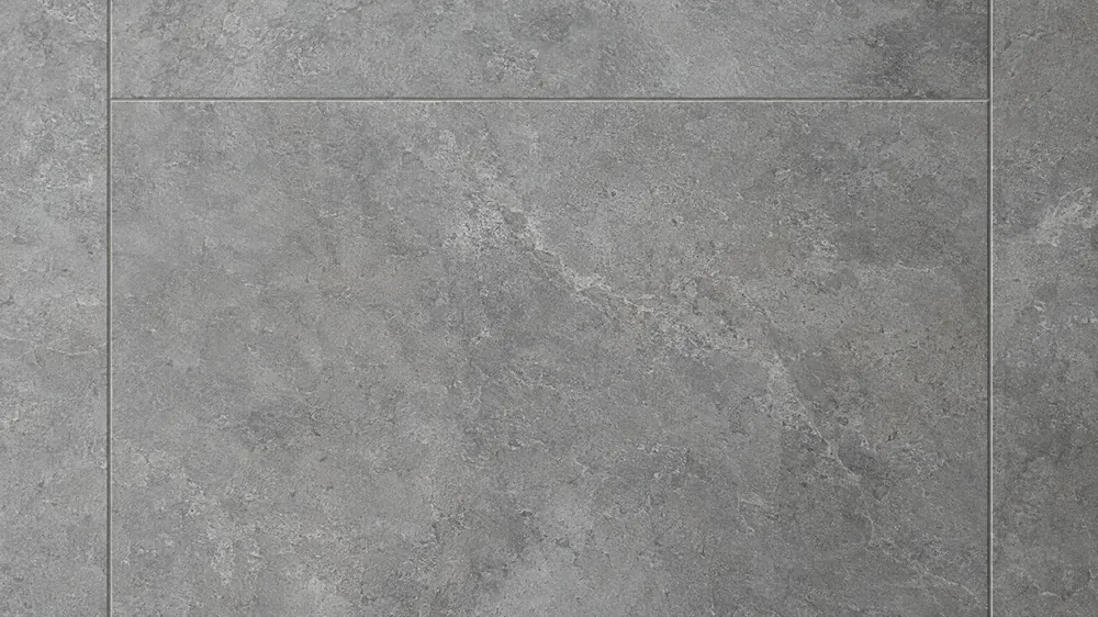 Close-up of large-format gray porcelain tiles with a subtle stone texture and thin grout lines
